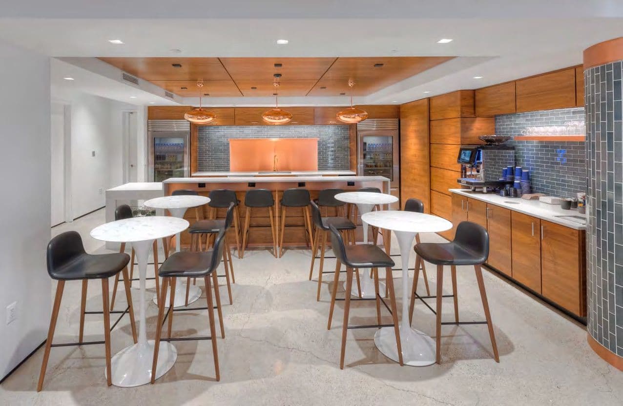 Kitchen galley with high-top tables and bar stools
